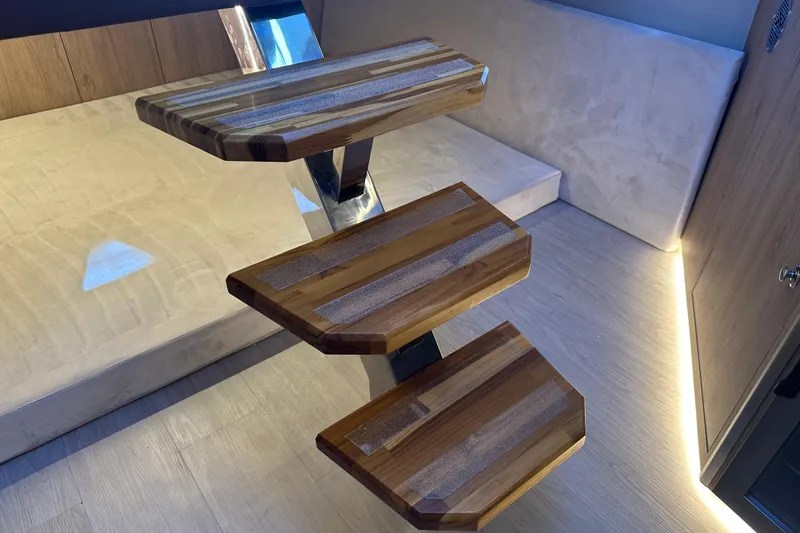  Yacht Photos Pics Wooden staircase inside 2025 NX Boats 370, featuring modern design and ambient lighting.