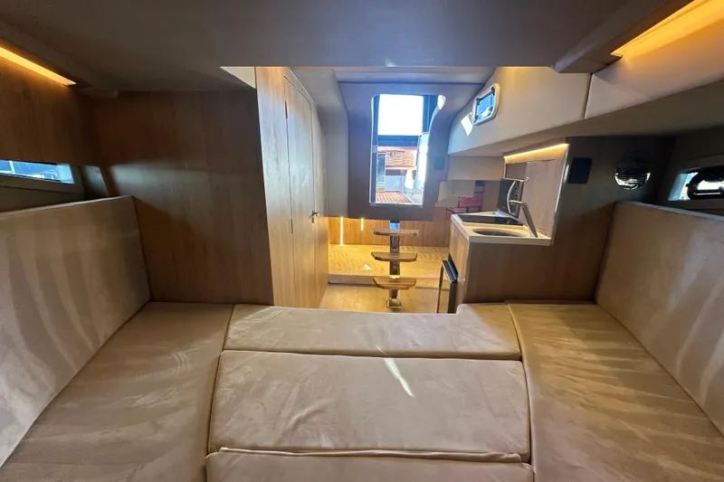  Yacht Photos Pics Luxurious interior of 2025 NX Boats 370, featuring modern kitchen and cozy seating area.
