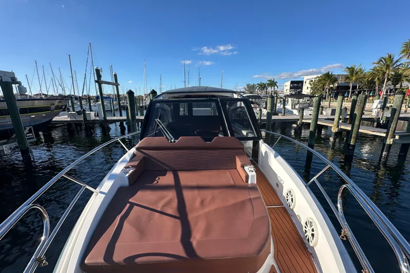  Yacht Photos Pics 2025 NX Boats 370 at marina, featuring spacious deck and luxurious seating.