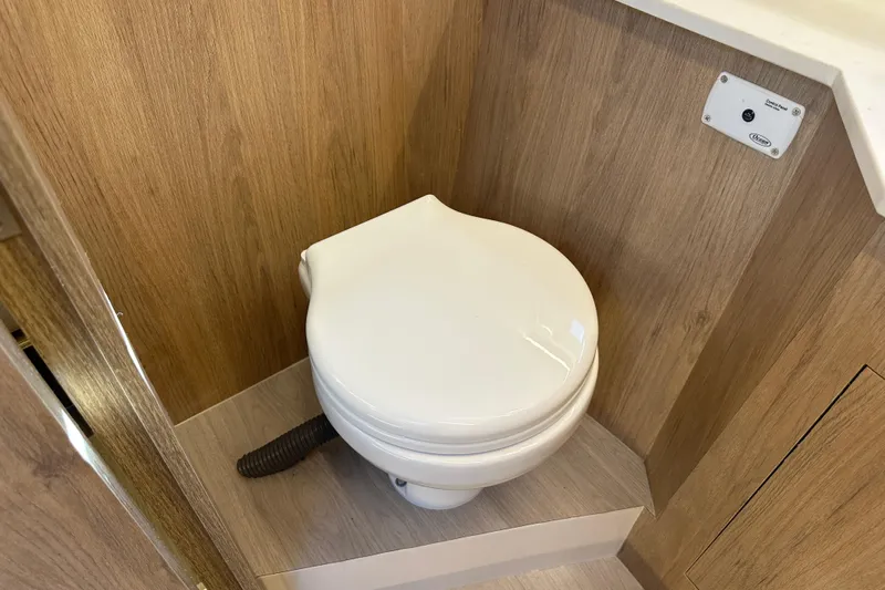  Yacht Photos Pics 2025 NX Boats 370 bathroom with modern toilet and wood paneling.