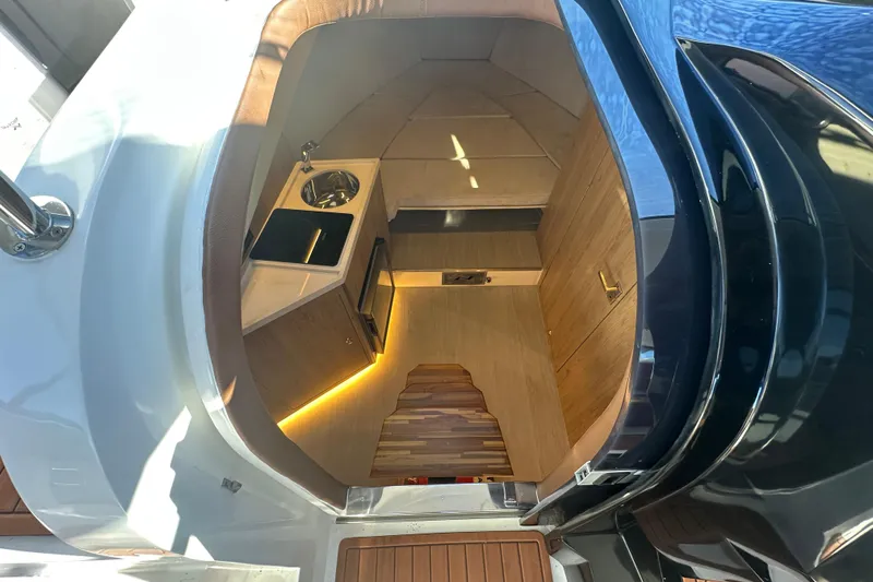  Yacht Photos Pics Interior of 2025 NX Boats 370, featuring a compact kitchenette and modern wood finishes.