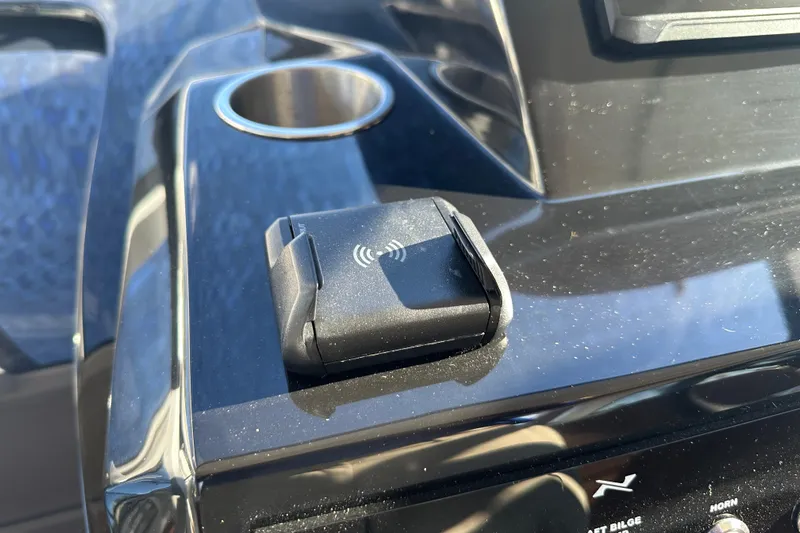  Yacht Photos Pics Wireless charging pad on 2025 NX Boats 370 dashboard, featuring sleek black design.