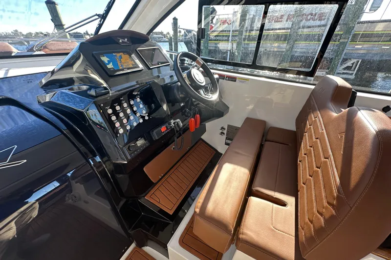  Yacht Photos Pics 2025 NX Boats 370 cockpit with modern controls and brown leather seating.