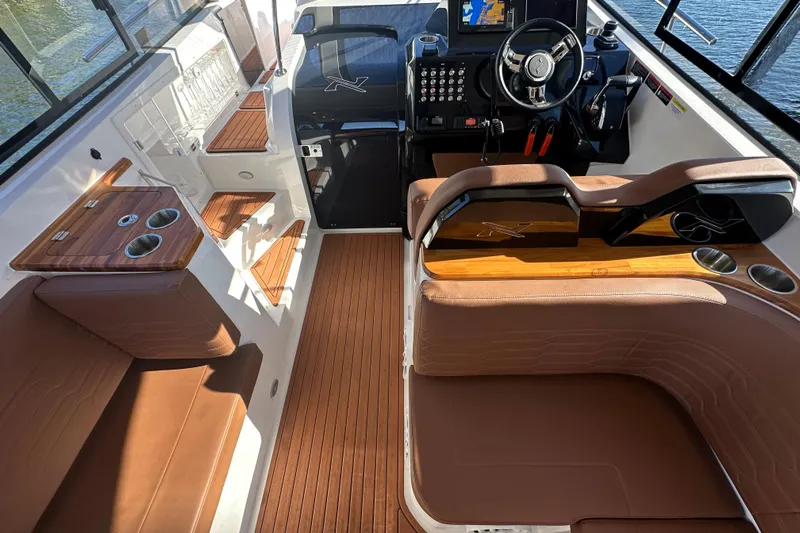  Yacht Photos Pics 2025 NX Boats 370 interior with brown leather seating, modern helm, and wooden accents.