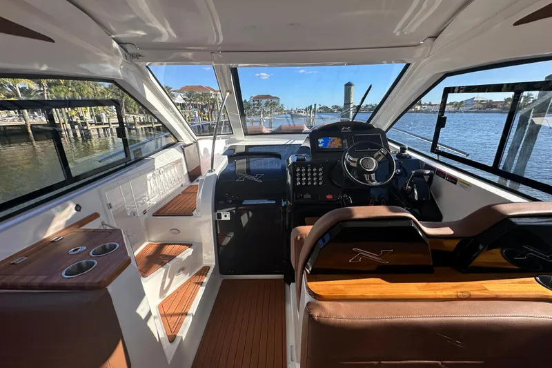  Yacht Photos Pics Interior of 2025 NX Boats 370, featuring modern helm and luxurious seating.