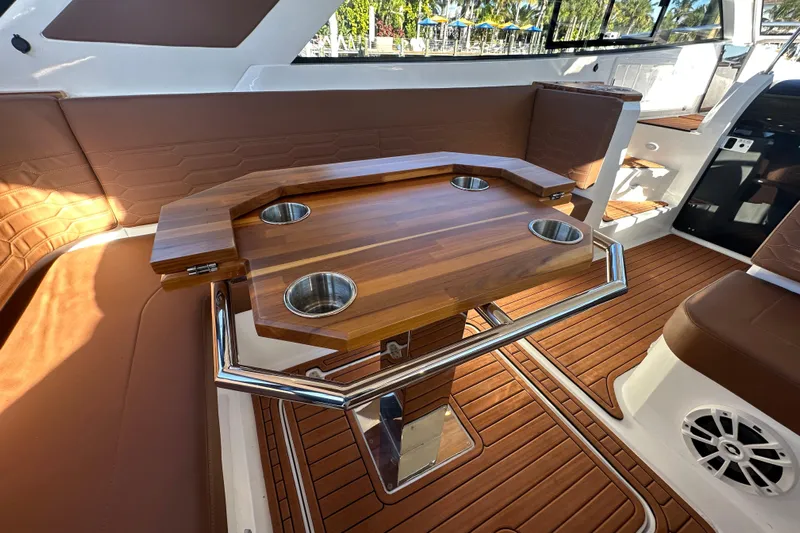 Yacht Photos Pics Luxury interior of 2025 NX Boats 370 with wooden table and cup holders.