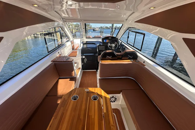 Yacht Photos Pics Luxurious interior of 2025 NX Boats 370, featuring elegant seating and modern helm.