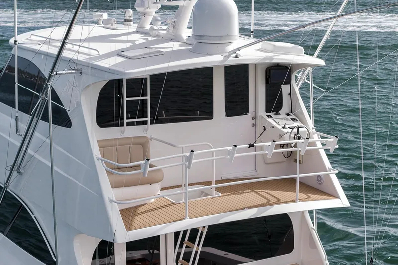 Bottom Line Yacht Photos Pics 2012 Viking 60 Enclosed Bridge yacht with upper deck, ocean backdrop.