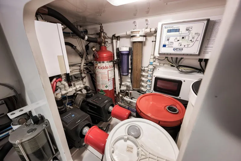 Bottom Line Yacht Photos Pics Engine room of 2012 Viking 60 Enclosed Bridge yacht, featuring equipment and safety systems.