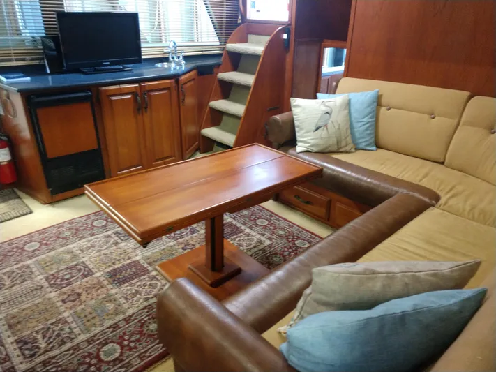Elizabeth Rose Yacht Photos Pics 1981 Tollycraft 43 Motoryacht interior with cozy seating, wooden table, and TV.