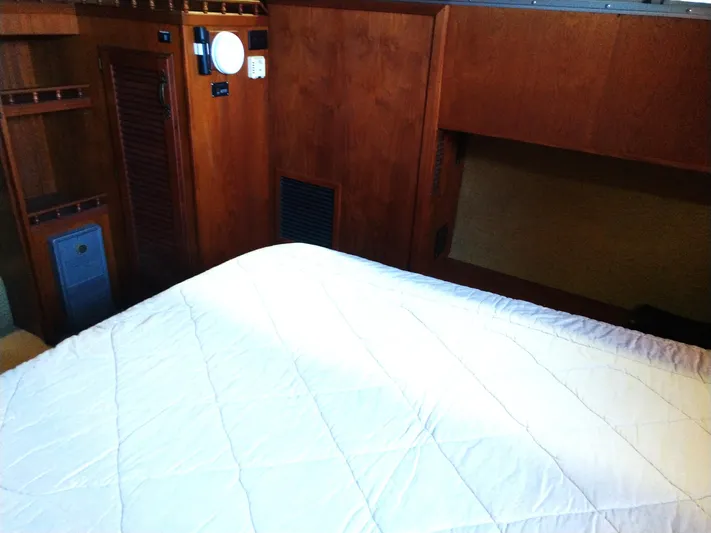 Elizabeth Rose Yacht Photos Pics Interior cabin of 1981 Tollycraft 43 Motoryacht with wooden paneling and bed.