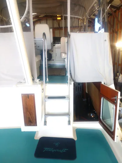 Elizabeth Rose Yacht Photos Pics 1981 Tollycraft 43 Motoryacht interior with teal flooring and ladder to upper deck.