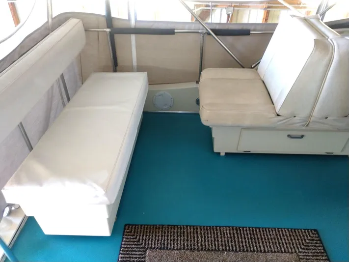 Elizabeth Rose Yacht Photos Pics Interior of 1981 Tollycraft 43 Motoryacht with white seating and blue carpet.