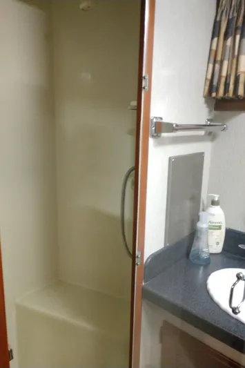 Elizabeth Rose Yacht Photos Pics 1981 Tollycraft 43 Motoryacht bathroom with shower, sink, and toiletries.