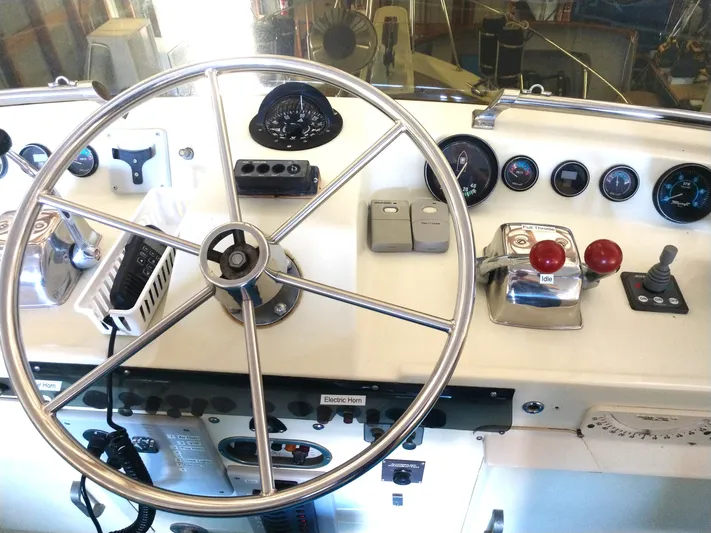Elizabeth Rose Yacht Photos Pics 1981 Tollycraft 43 Motoryacht helm with steering wheel and control panel.