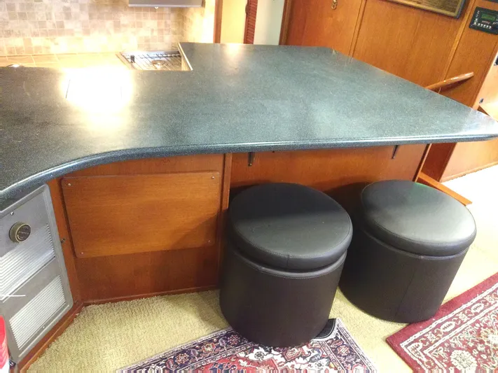 Elizabeth Rose Yacht Photos Pics Interior of 1981 Tollycraft 43 Motoryacht with countertop and two black stools.