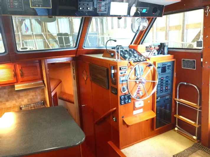 Elizabeth Rose Yacht Photos Pics 1981 Tollycraft 43 Motoryacht helm with wooden interior, steering wheel, and control panels.