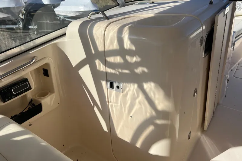  Yacht Photos Pics 2011 Grady-White Freedom 307 boat interior with radio and storage compartment.