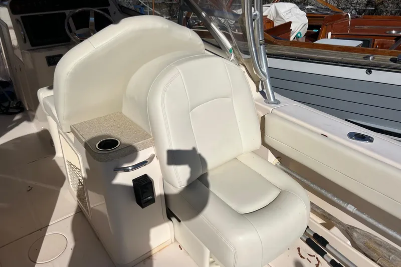  Yacht Photos Pics 2011 Grady-White Freedom 307 boat interior with white seating and cup holder.