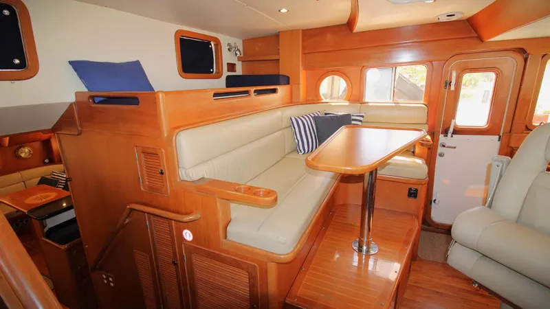 The Concession Yacht Photos Pics Interior of 2001 Selene 53 Pilothouse yacht with wooden furnishings and seating area.