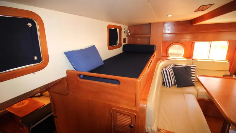 The Concession Yacht Photos Pics Interior of 2001 Selene 53 Pilothouse with cozy seating and wooden finishes.