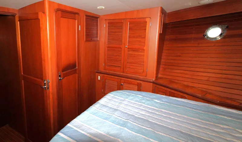 The Concession Yacht Photos Pics 2001 Selene 53 Pilothouse cabin with wooden interior and bed.