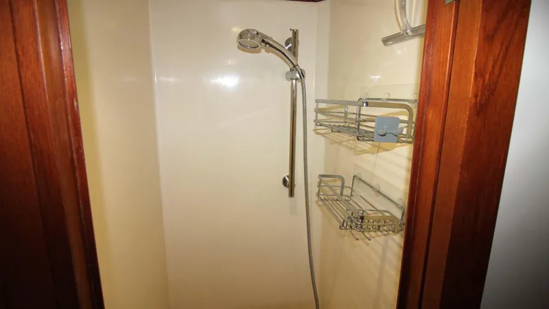 The Concession Yacht Photos Pics Shower area in 2001 Selene 53 Pilothouse yacht with wooden trim and metal fixtures.