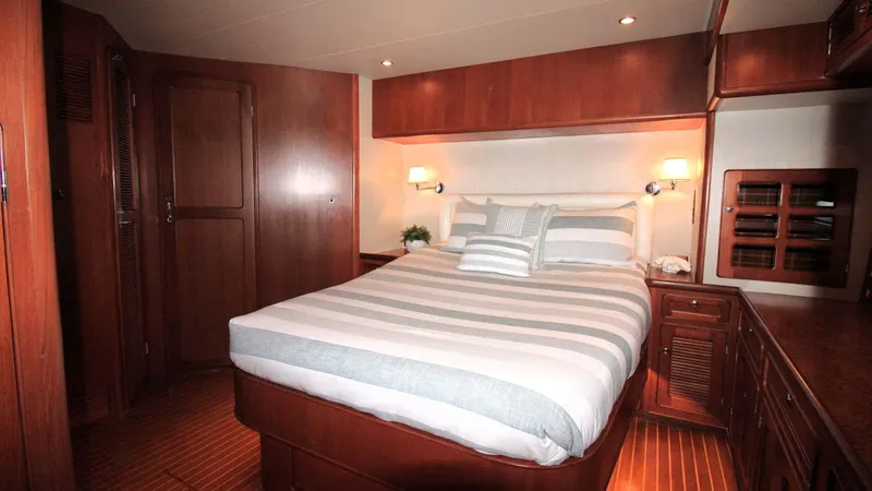 The Concession Yacht Photos Pics Luxurious cabin interior of 2001 Selene 53 Pilothouse yacht with cozy bed and wooden furnishings.