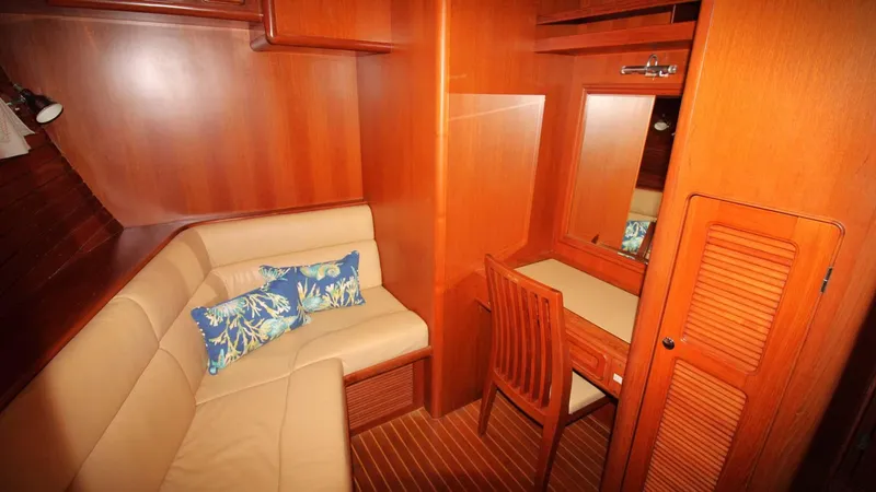The Concession Yacht Photos Pics Luxurious wooden interior of 2001 Selene 53 Pilothouse with seating and vanity area.