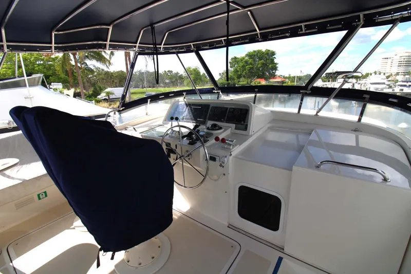 The Concession Yacht Photos Pics Pilothouse of 2001 Selene 53 yacht with covered captain's chair and navigation equipment.