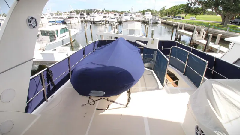 The Concession Yacht Photos Pics Selene 53 Pilothouse 2001 yacht deck with covered equipment, docked at marina.