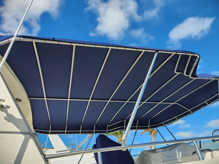 The Concession Yacht Photos Pics Blue canopy on 2001 Selene 53 Pilothouse yacht against a clear sky.