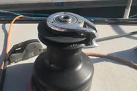 Winch on 2005 Finot Open 50 sailboat deck, docked at marina.