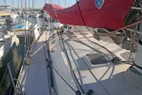 2005 Finot Open 50 sailboat with red sail cover, docked in a marina.