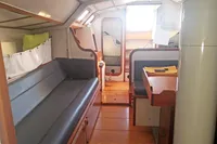 Interior of 2005 Finot Open 50 sailboat with seating and wooden finishes.