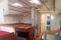 Interior of 2005 Finot Open 50 sailboat with navigation equipment and wooden furnishings.