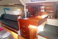 Interior of 2005 Finot Open 50 yacht with navigation equipment and wooden cabinetry.