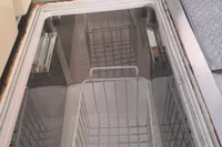 Interior view of a 2005 Finot Open 50 yacht's storage compartment with wire baskets.