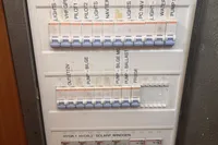 Electrical panel on a 2005 Finot Open 50 yacht with labeled switches.