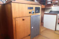 Interior of 2005 Finot Open 50 yacht with wooden cabinetry and navigation equipment.