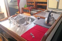 Galley kitchen in 2005 Finot Open 50 yacht with sink and kettle.