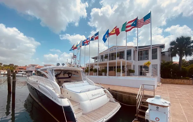  Yacht Photos Pics Luxury yacht Viking Princess V 58 docked near a marina with international flags, 2006 model.