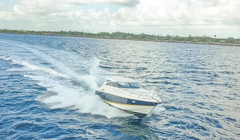  Yacht Photos Pics 2006 Viking Princess V 58 yacht cruising on open water under a cloudy sky.
