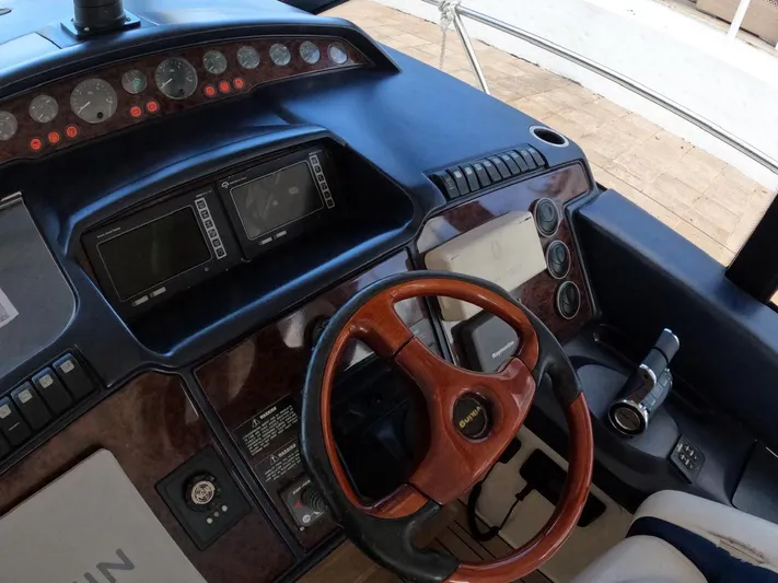  Yacht Photos Pics 2006 Viking Princess V 58 yacht helm with wood steering wheel and modern controls.