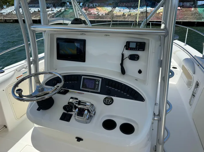  Yacht Photos Pics 2008 Boston Whaler 320 Outrage helm with navigation equipment and steering wheel.