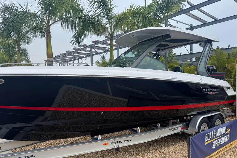  Yacht Photos Pics 2025 Monterey Elite 27 OB boat on trailer, surrounded by palm trees.