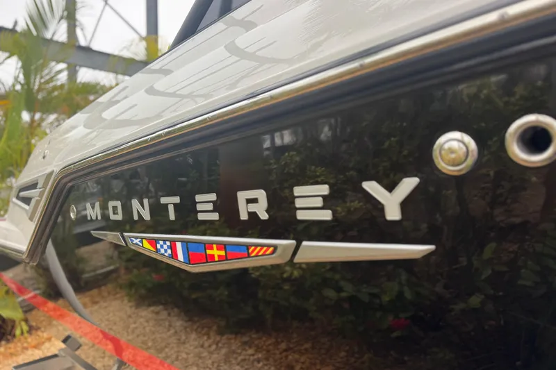  Yacht Photos Pics 2025 Monterey Elite 27 OB boat with sleek design and nautical flags.