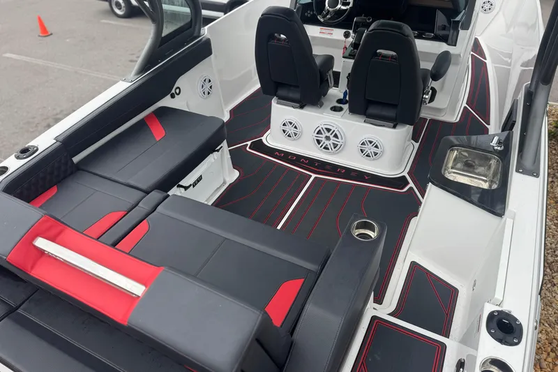  Yacht Photos Pics 2025 Monterey Elite 27 OB boat interior with black and red seating, speakers, and sink.