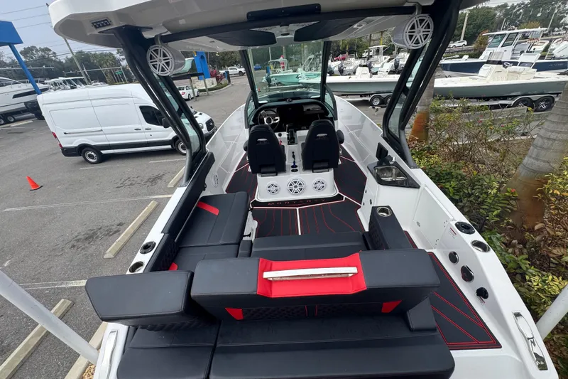  Yacht Photos Pics 2025 Monterey Elite 27 OB boat interior with modern seating and dashboard in a marina setting.