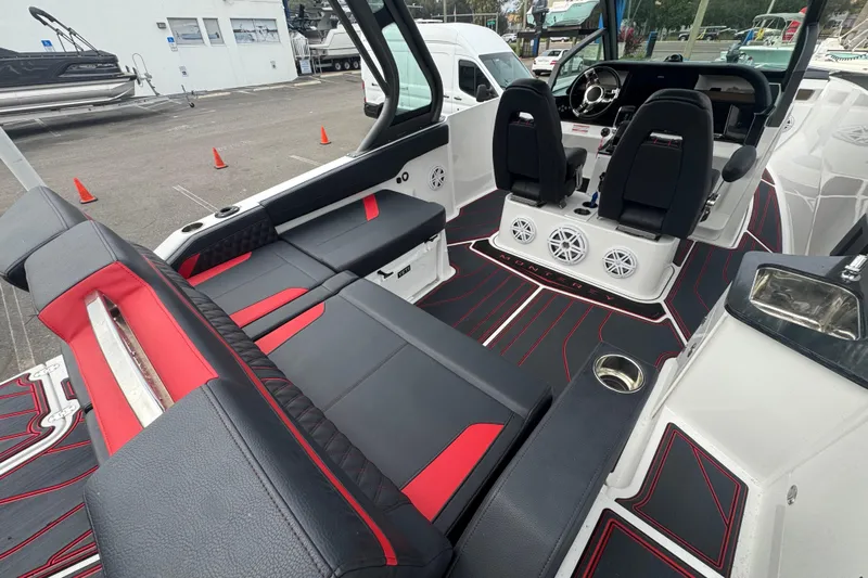  Yacht Photos Pics 2025 Monterey Elite 27 OB boat interior with sleek black and red seating, modern dashboard.